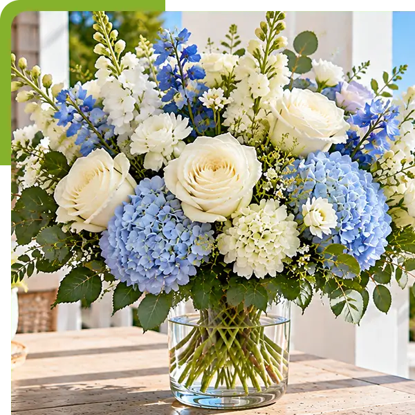 Blue hydrangea and white rose bouquet overlooking a coastal harbor.