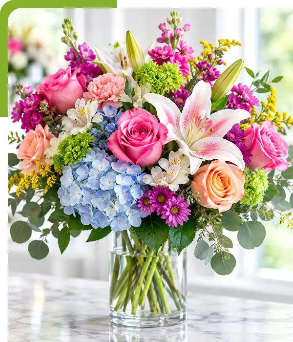 Fresh mixed flower arrangement with roses, lilies, hydrangeas, and greenery for East Lyme flower delivery